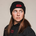 Black SBD Beanie with red embroidered logo, worn by an athlete