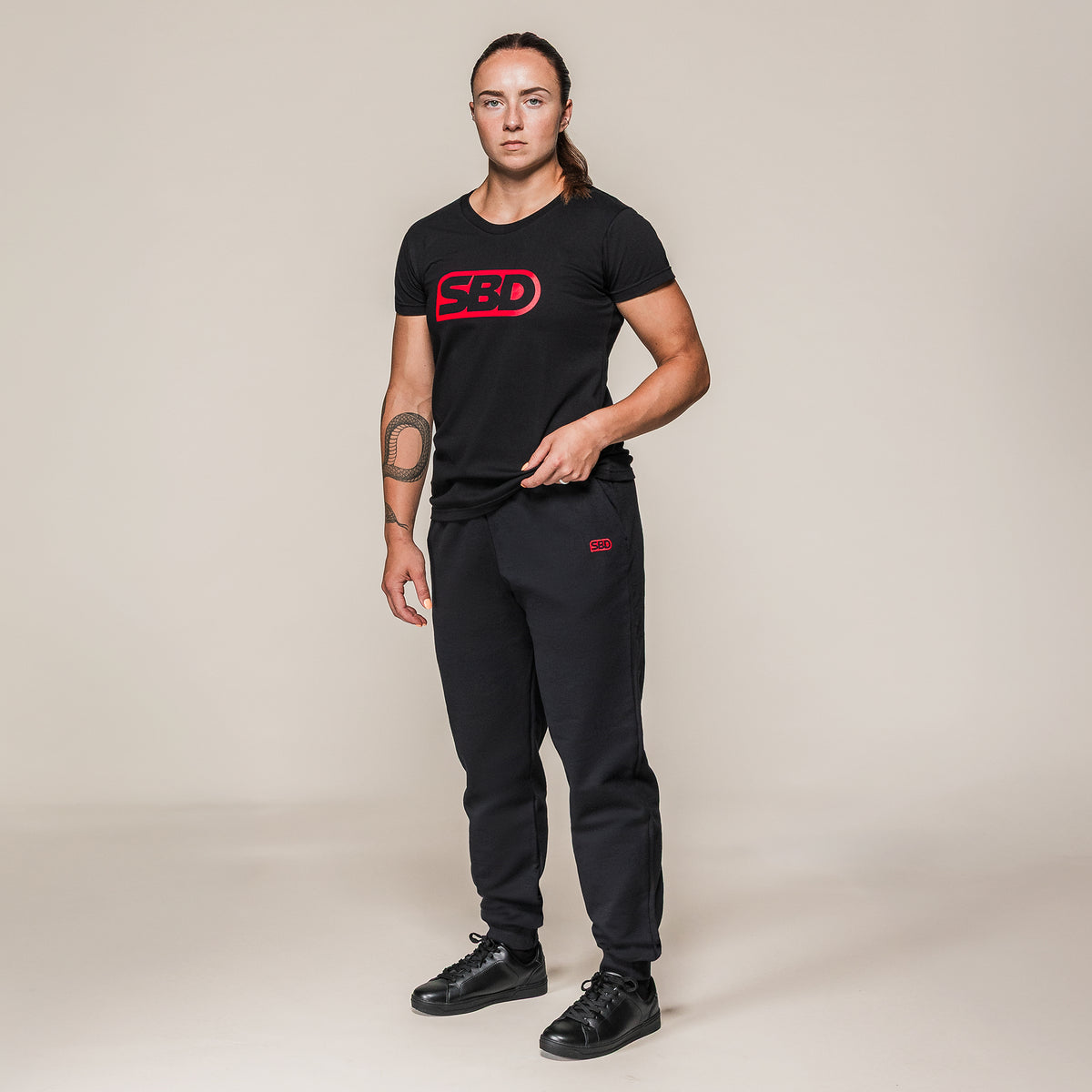 Black SBD T-Shirt, full-length view worn with joggers