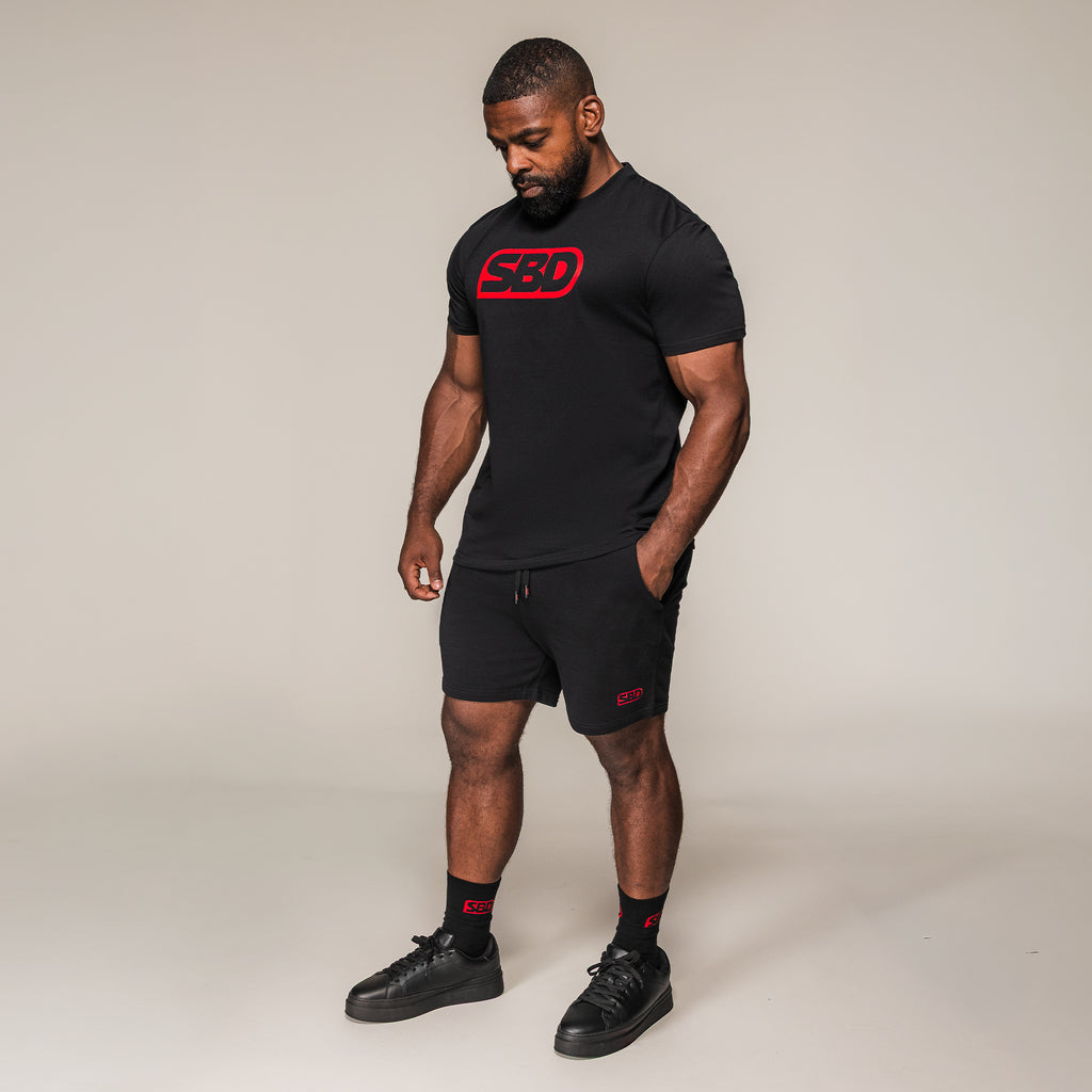 Black SBD T-Shirt with large red chest logo, full-length view on an athlete