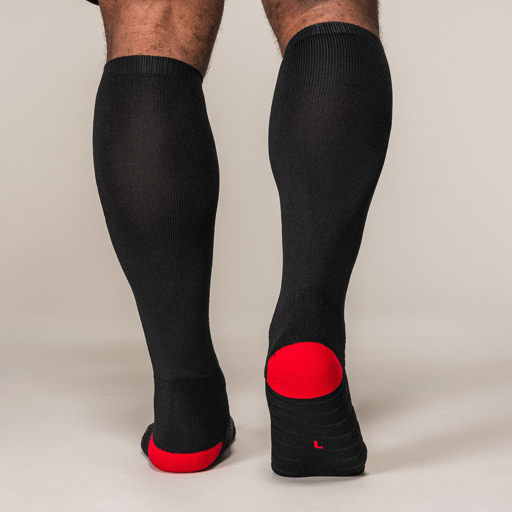 Black and red SBD Deadlift Socks, rear view showing the heel panels