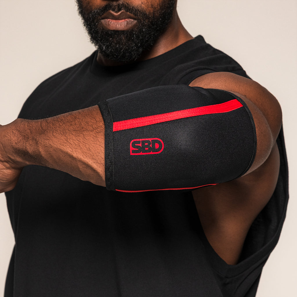 Black and red SBD Elbow Sleeve worn with the elbow bent