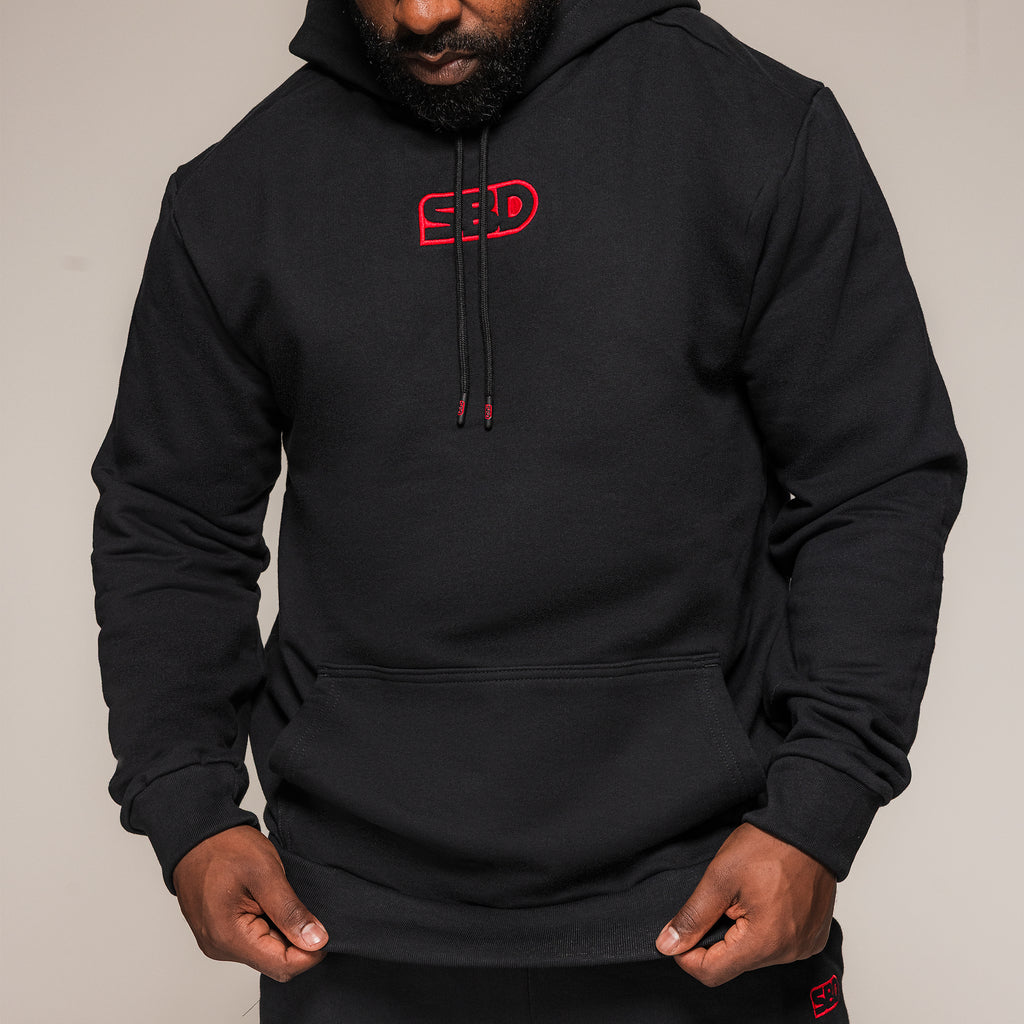 Black SBD Hoodie, close-up showing the chest logo, drawstrings and front pocket