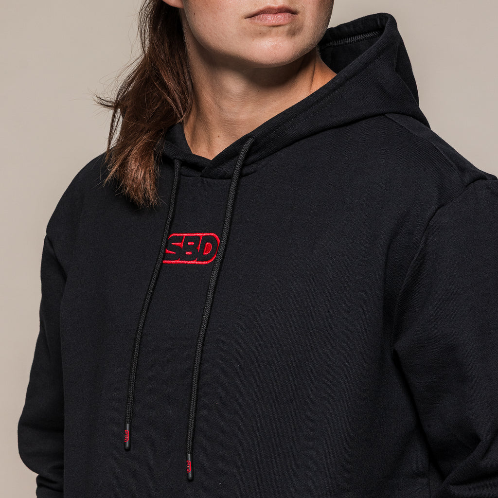 Black SBD Hoodie, close-up of the red chest logo and drawstrings