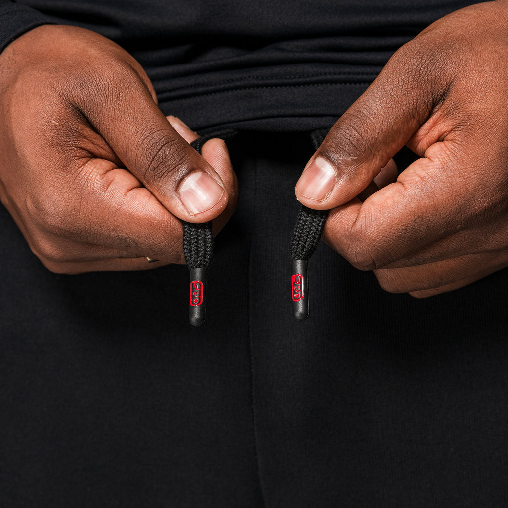 Black SBD Joggers, close-up of the branded drawstring ends