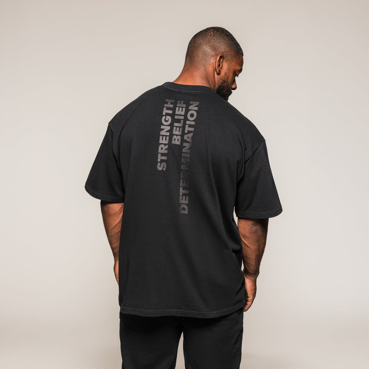 Black SBD Oversized T-Shirt, rear view showing the vertical back print