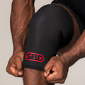 SBD Powerlifting Knee Sleeve, close-up of the black fabric and red logo