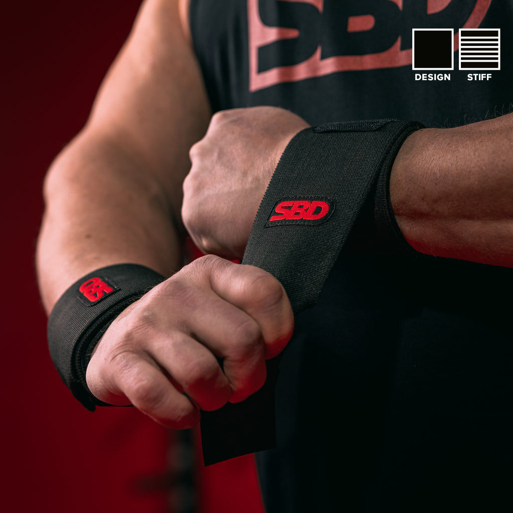 SBD Stiff Wrist Wraps in black and red being fastened around the wrist