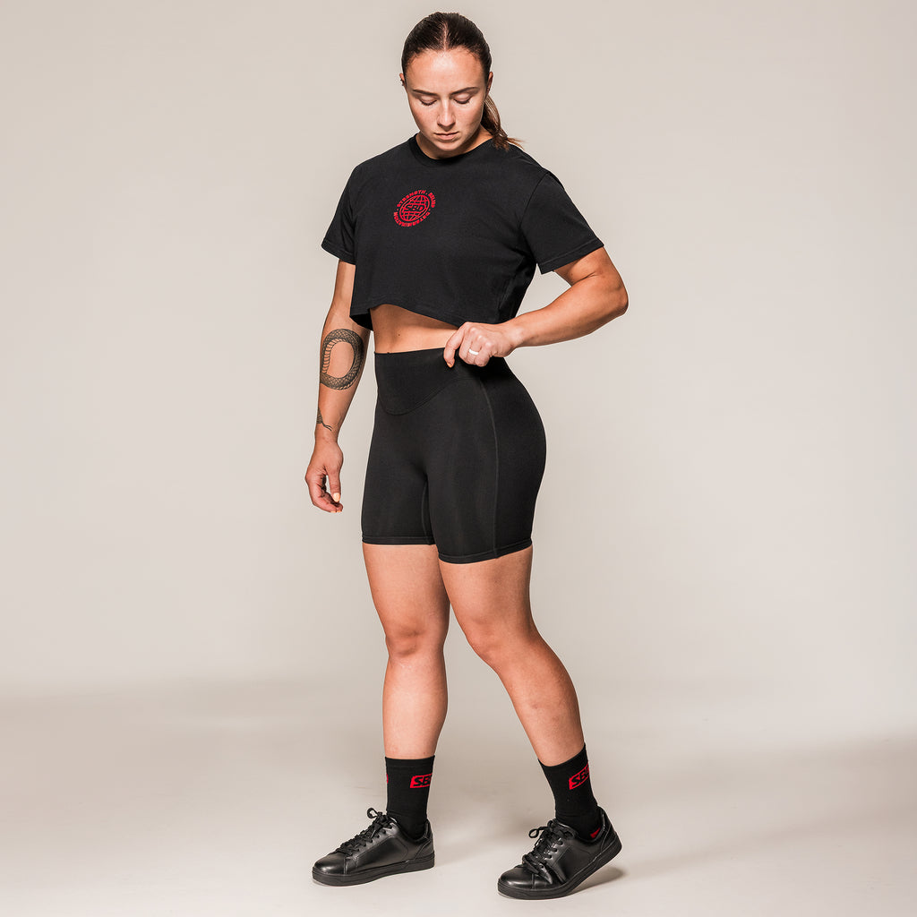 Women's black SBD Training Shorts, full-length view on an athlete