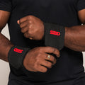 Black and red SBD Flexible Wrist Wraps being fastened
